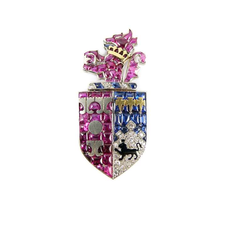 Ruby, diamond, sapphire and enamel armorial clip brooch depicting the arms of Smith of Bristol, Somerset